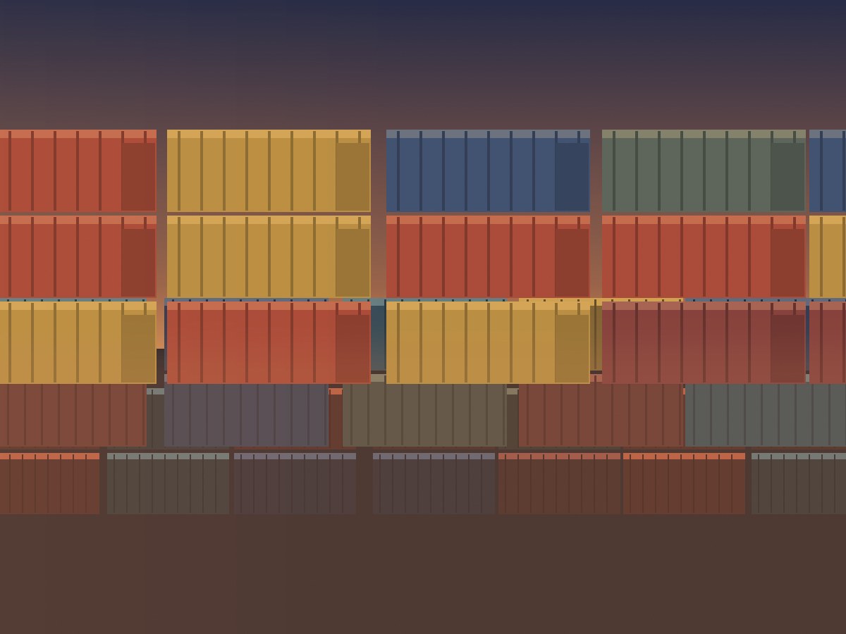 Stacked shipping containers at a trading yard in warm evening light
